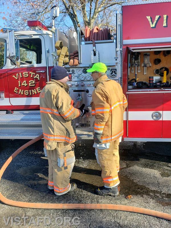 Probationary Firefighter/EMT Candidate Andrew Korman and Assistant Chief Mike Peck going over Engine 142 pumping operations - 11/19/23