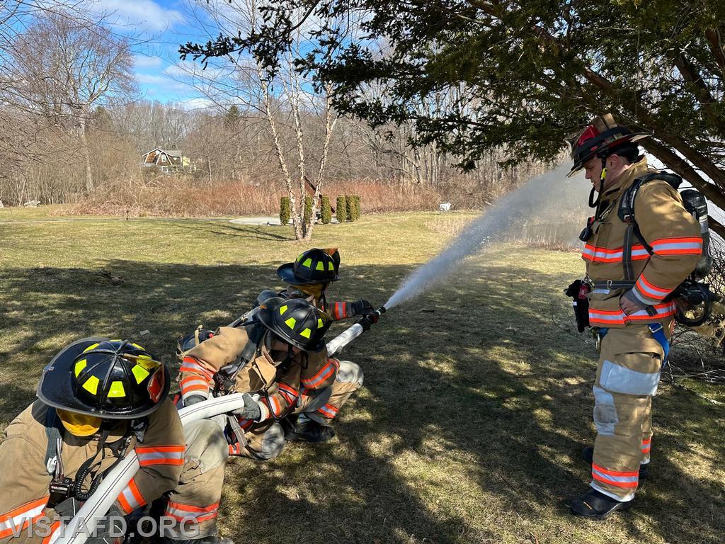 Vista Firefighters practicing how to operate a 2-1/2&quot; hoseline as Lt. Marc Baiocco looks on - 03/19/23