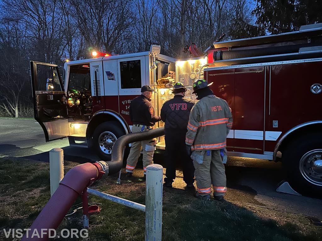 Firefighter/EMT Ryan Huntsman operating the Engine 143 pump panel during the hydrant service as Lt. Marc Baiocco and Firefighter Eric Lavelanet look on - 04/10/23
