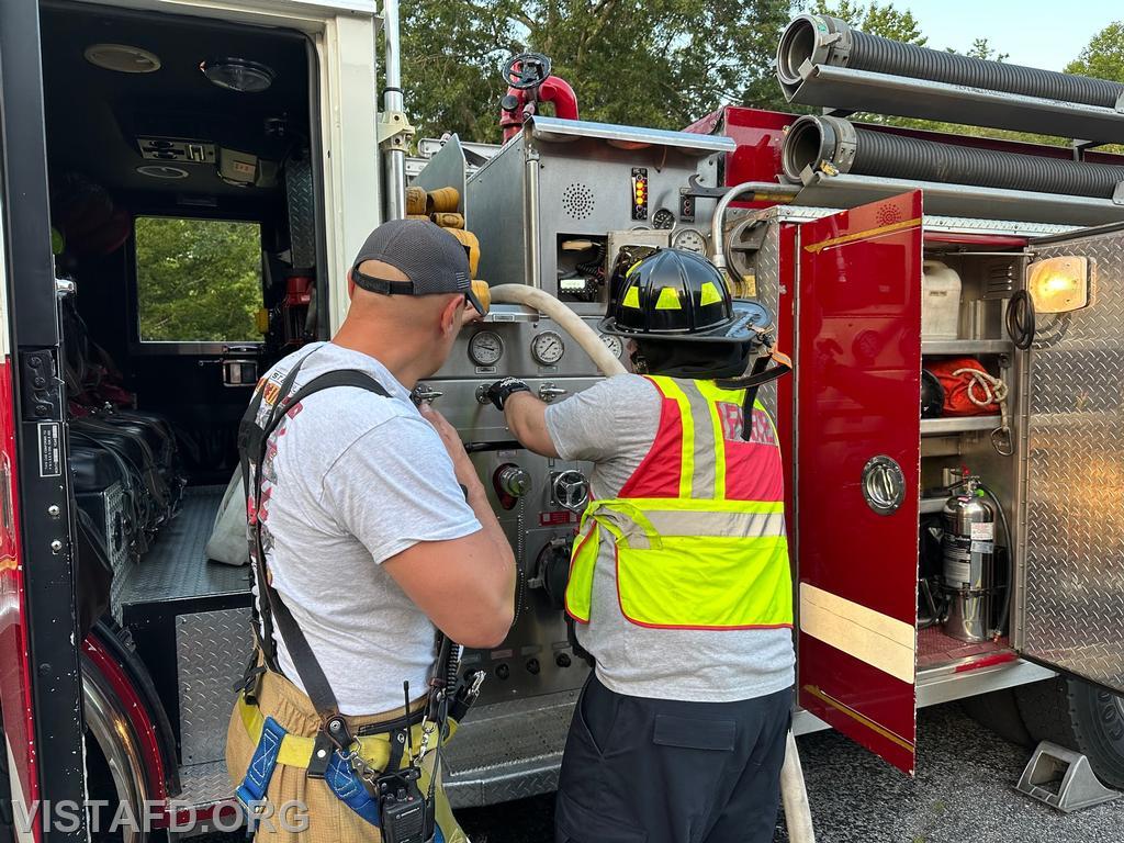 Firefighter/EMT Ryan Huntsman operating the Engine 143 pump panel as Captain Marc Baiocco looks on - 07/24/23
