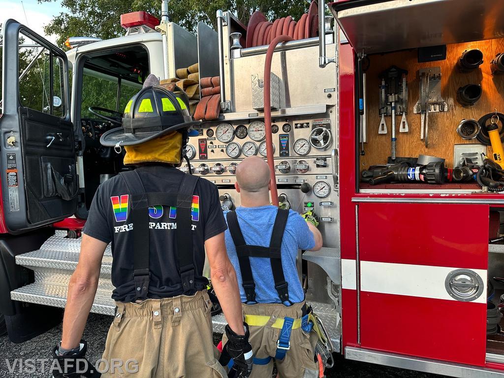 Foreman Ryan Ruggiero operating the Engine 142 pump panel as Probationary Firefighter/EMT Candidate Andy Korman looks on - 07/24/23