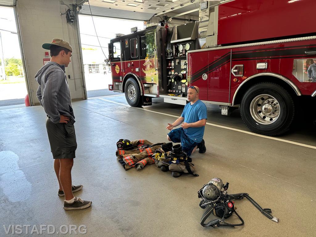 Foreman Ryan Ruggiero going over firefighting gear with Probationary Firefighter Teddy Goetz - 09/03/23