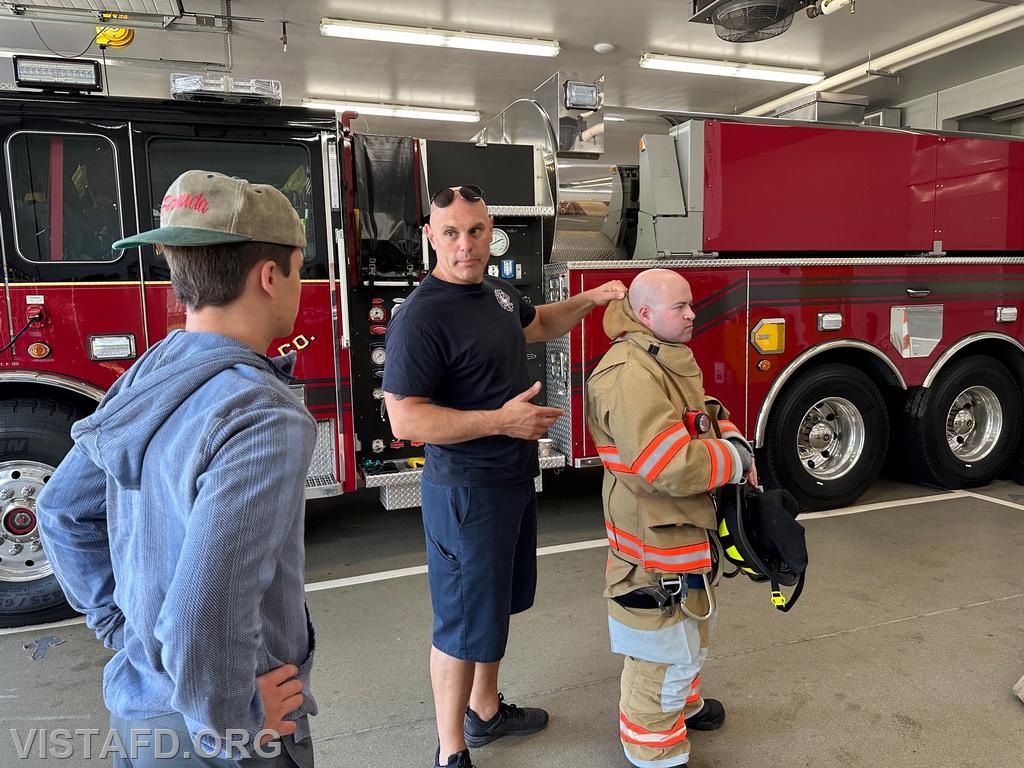 Captain Marc Baiocco and Foreman Ryan Ruggiero going over firefighting gear with Probationary Firefighter Teddy Goetz - 09/03/23