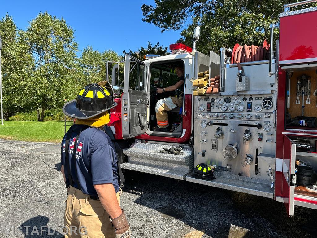 Probationary Firefighter/EMT Candidate Andy Korman practicing putting Engine 142 into pump operations while Foreman Brian Sferra looks on - 10/01/23