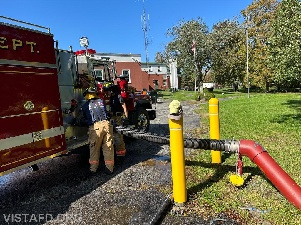 Foreman Brian Sferra going over how to hook Engine 142 up to a dry hydrant with Probationary Firefighter/EMT Candidate Andy Korman - 10/01/23