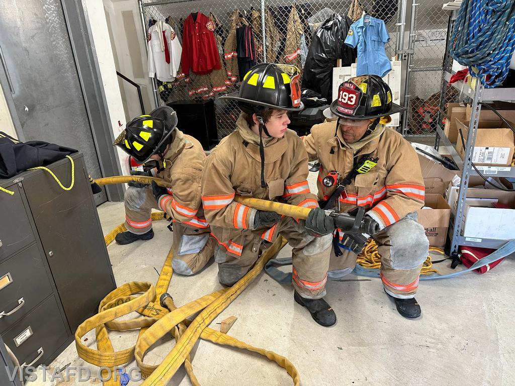 Firefighter Wilmer Cervantes going over hoseline advancement with Vista Fire Department personnel during &quot;Firefighter Skills Class&quot; - 03/24/24