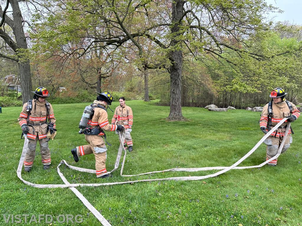 Vista Firefighters practicing hoseline advancement as Foreman Kyla Whalen looks on during &quot;Firefighter Skills Class&quot; - 05/05/24