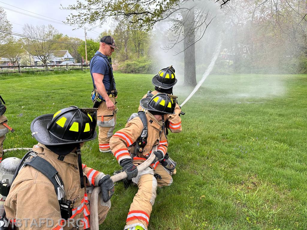 Vista Firefighters practicing hoseline advancement as Captain Marc Baiocco looks on during &quot;Firefighter Skills Class&quot; - 05/05/24