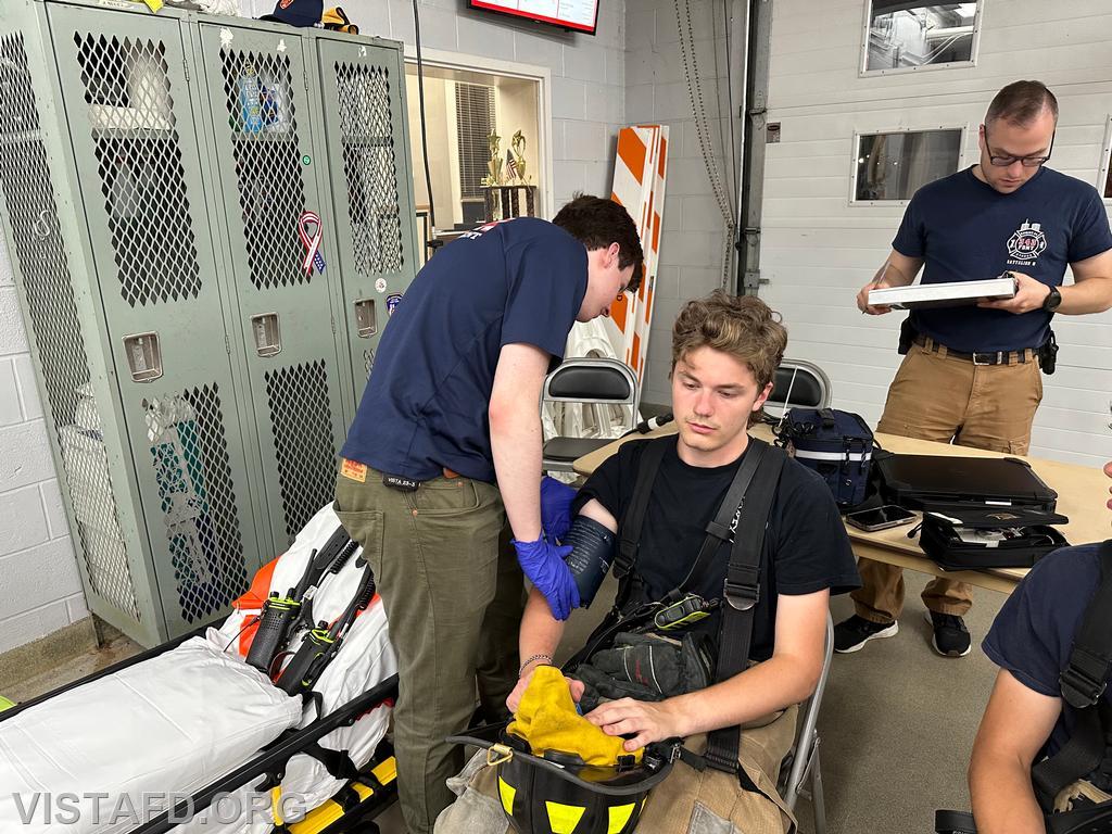 EMT Grant Vialardi conducting rehab operations on Probationary Firefighter Ty Graygor as Assistant Chief Brian Porco looks on - 08/12/24