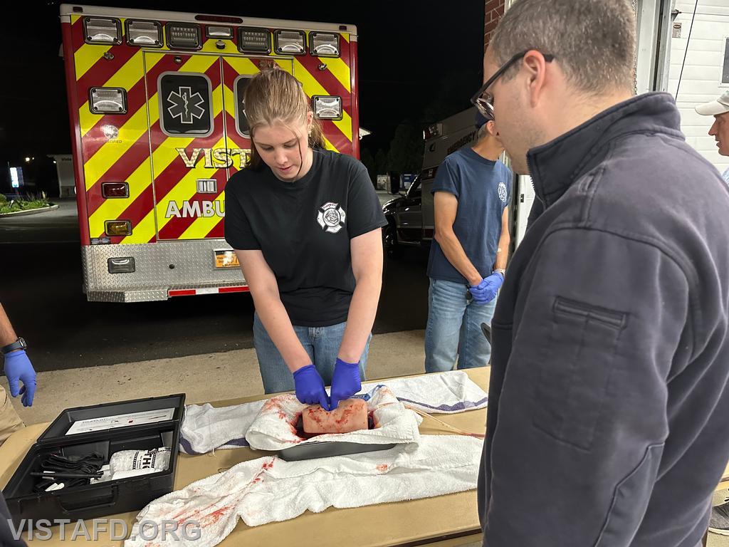 Probationary EMT Amanda Aalto going over how to pack a wound as Assistant Chief Brian Porco looks on - 09/23/24