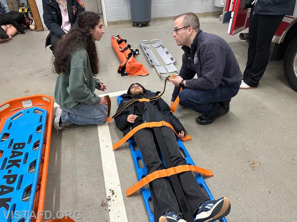 Assistant Chief Brian Porco going over how to use spider straps with Probationary EMT Candidate Skyla Warren during the &quot;lifting & moving&quot; drill - 11/25/24