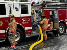 Probationary Firefighter Peter Cipriano and Probationary Firefighter Dan Hochman operating the E-143 pump panel