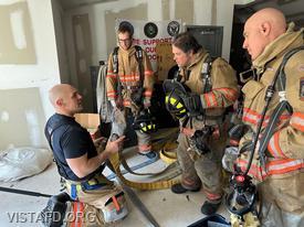 Captain Marc Baiocco reviewing V.E.I.S. (Vent, Enter, Isolate, and Search) procedures during the "Firefighter Skills Class"