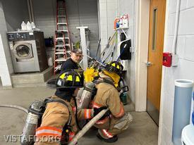 Captain Marc Baiocco goes over the hoseline advancement evolution with Firefighter Dan Hochman and Probationary Firefighter David Fignar